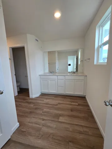 a view of a kitchen with wooden floor and a sink