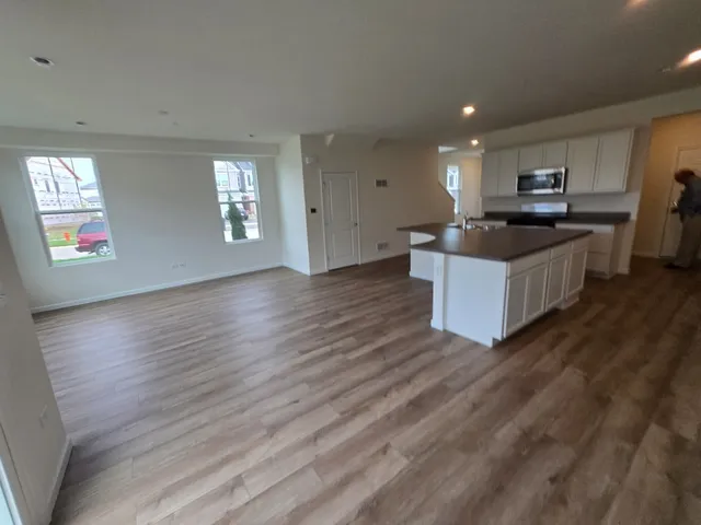 an open kitchen with sink and cabinets