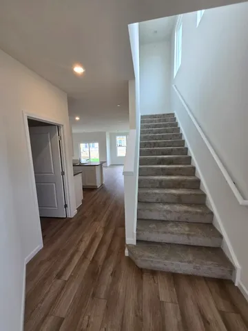 a view of a hallway view with wooden floor and stairs