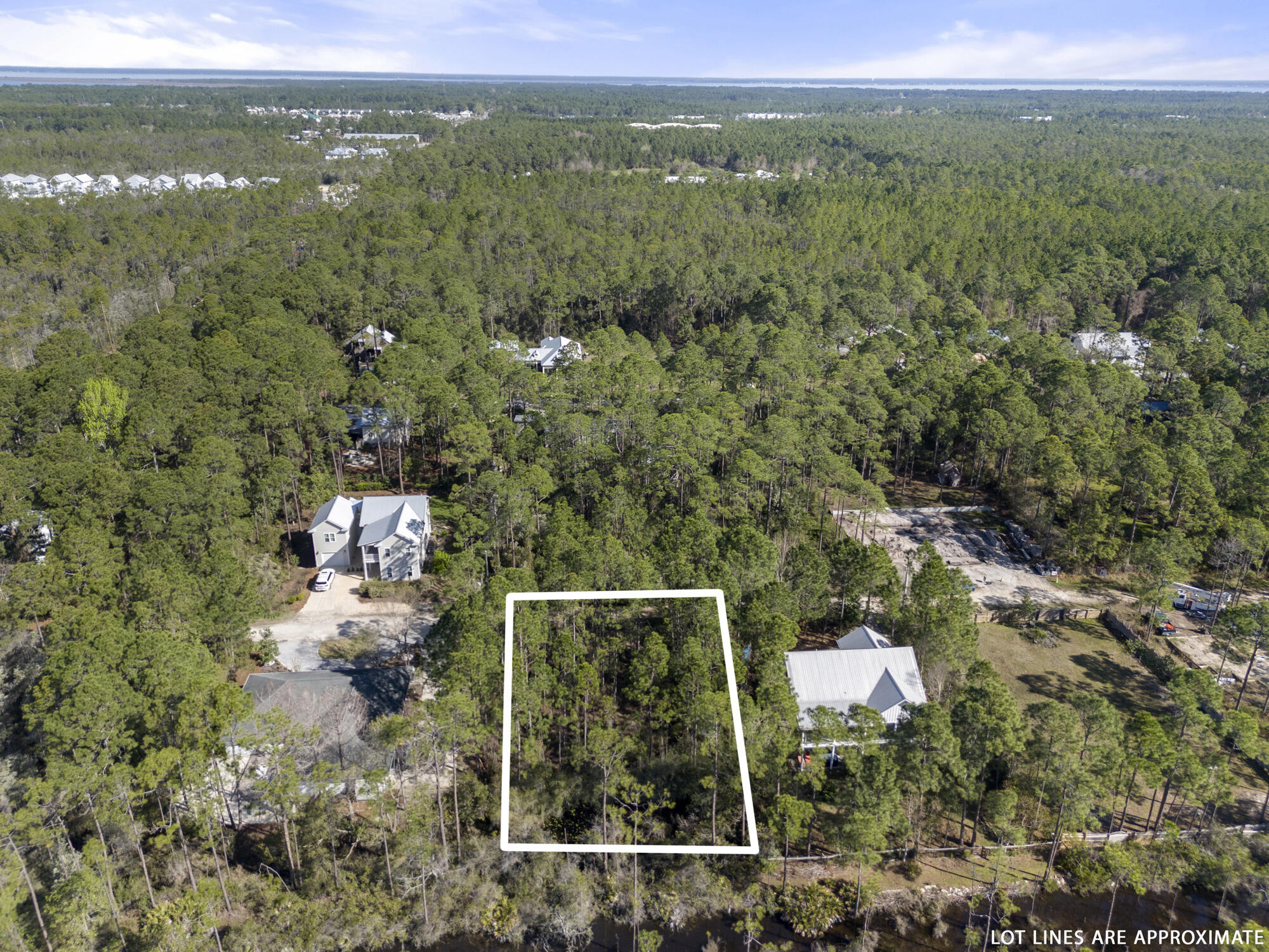 Lot 4 Calm Gulf Drive Santa Rosa Beach, FL 32459 - Photo 24 of 36 a view of a city with lush green forest