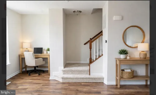 a view of entryway and hall with wooden floor