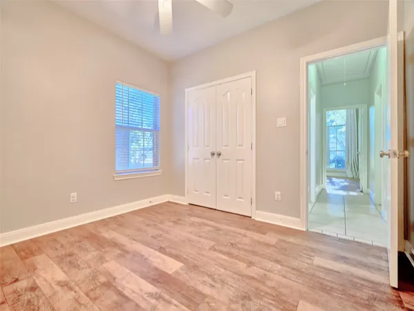an empty room with window and wooden floor