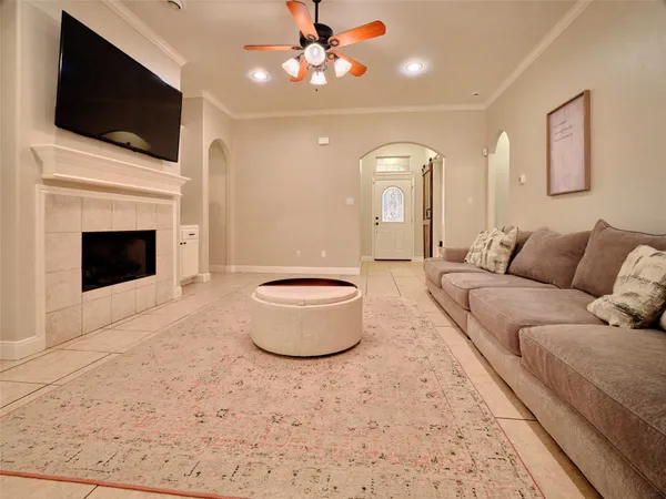a living room with furniture a fireplace and a flat screen tv