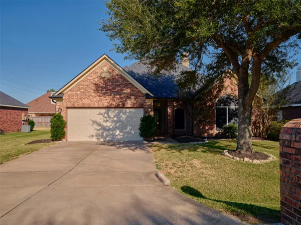 a view of a house with a yard and tree s