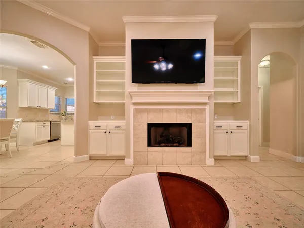 a living room with a flat screen tv and a fireplace
