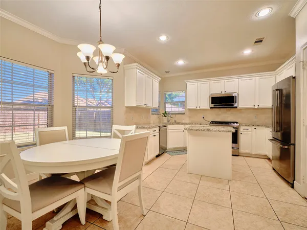 a large kitchen with kitchen island a sink counter space and stainless steel appliances