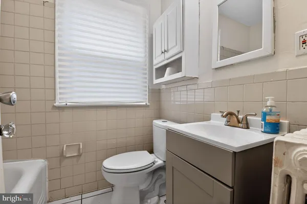 a bathroom with a sink toilet and a mirror