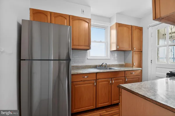 a kitchen with stainless steel appliances granite countertop a refrigerator sink and cabinets