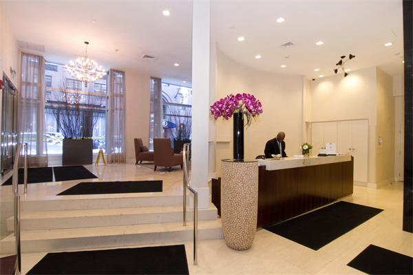 80 Broad Street, Unit 603 Boston, MA 02110 - Photo 1 of 9 a view of living room with furniture and flowers