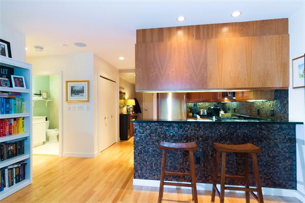 80 Broad Street, Unit 603 Boston, MA 02110 - Photo 4 of 9 a kitchen with a table and chairs in it