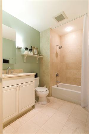 80 Broad Street, Unit 603 Boston, MA 02110 - Photo 6 of 9 a bathroom with a sink a toilet and shower