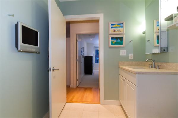80 Broad Street, Unit 603 Boston, MA 02110 - Photo 7 of 9 a bathroom with a sink and mirror