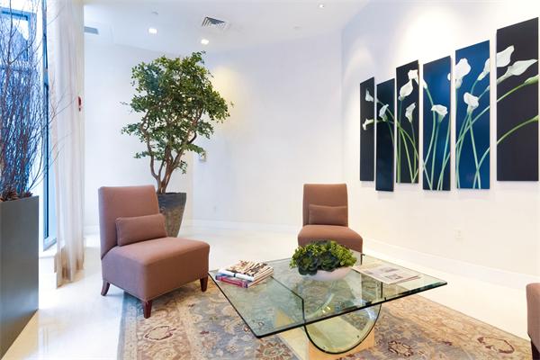 80 Broad Street, Unit 603 Boston, MA 02110 - Photo 8 of 9 a living room with furniture and a potted plant
