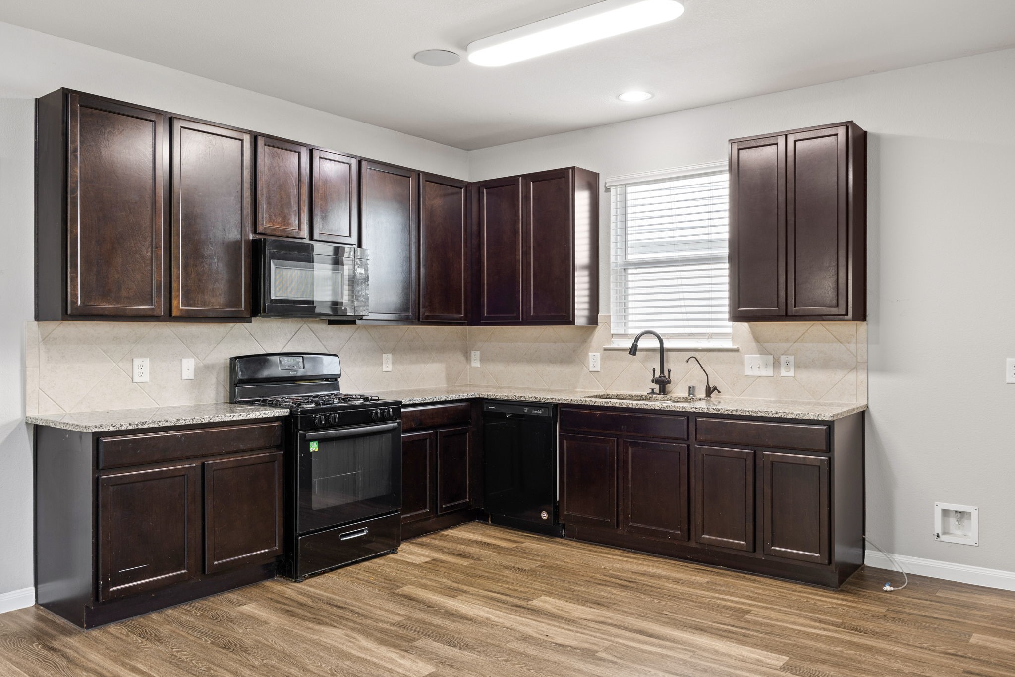 18606 Lansdowne Stream Path Katy, TX 77449 - Photo 20 of 39 a kitchen with stainless steel appliances granite countertop a sink stove and refrigerator