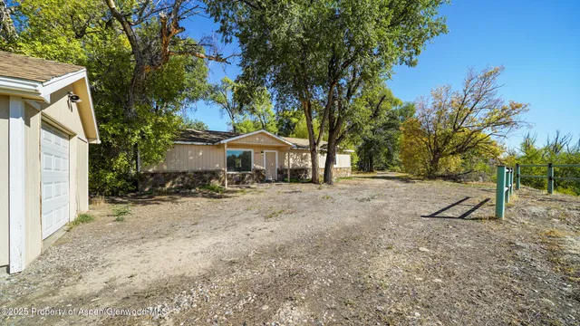 a view of house with trees in the background