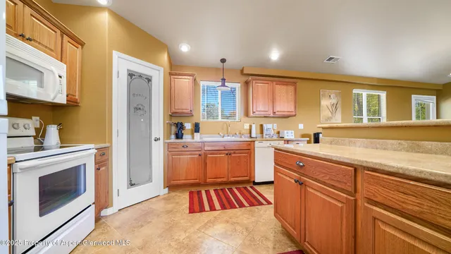 a kitchen with a sink stove and refrigerator