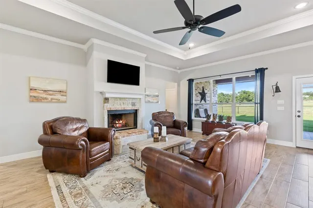 a living room with furniture a flat screen tv and a fireplace