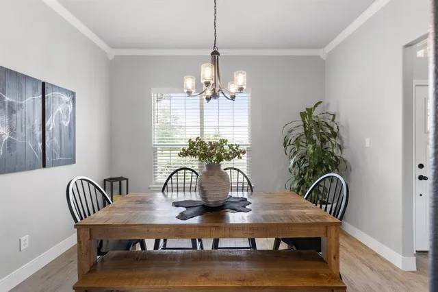a view of a dining room with furniture and chandelier