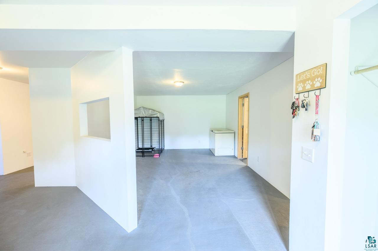 3201 Wilderness Road Makinen, MN 55763 - Photo 21 of 44 Interior space with light gray flooring and white walls, featuring a pass-through opening