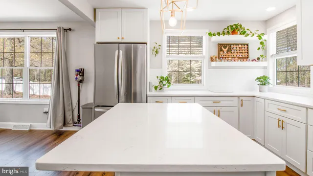 a kitchen with a stove a microwave a dining table and chairs