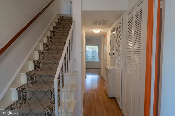 a view of a hallway with wooden floor and entryway
