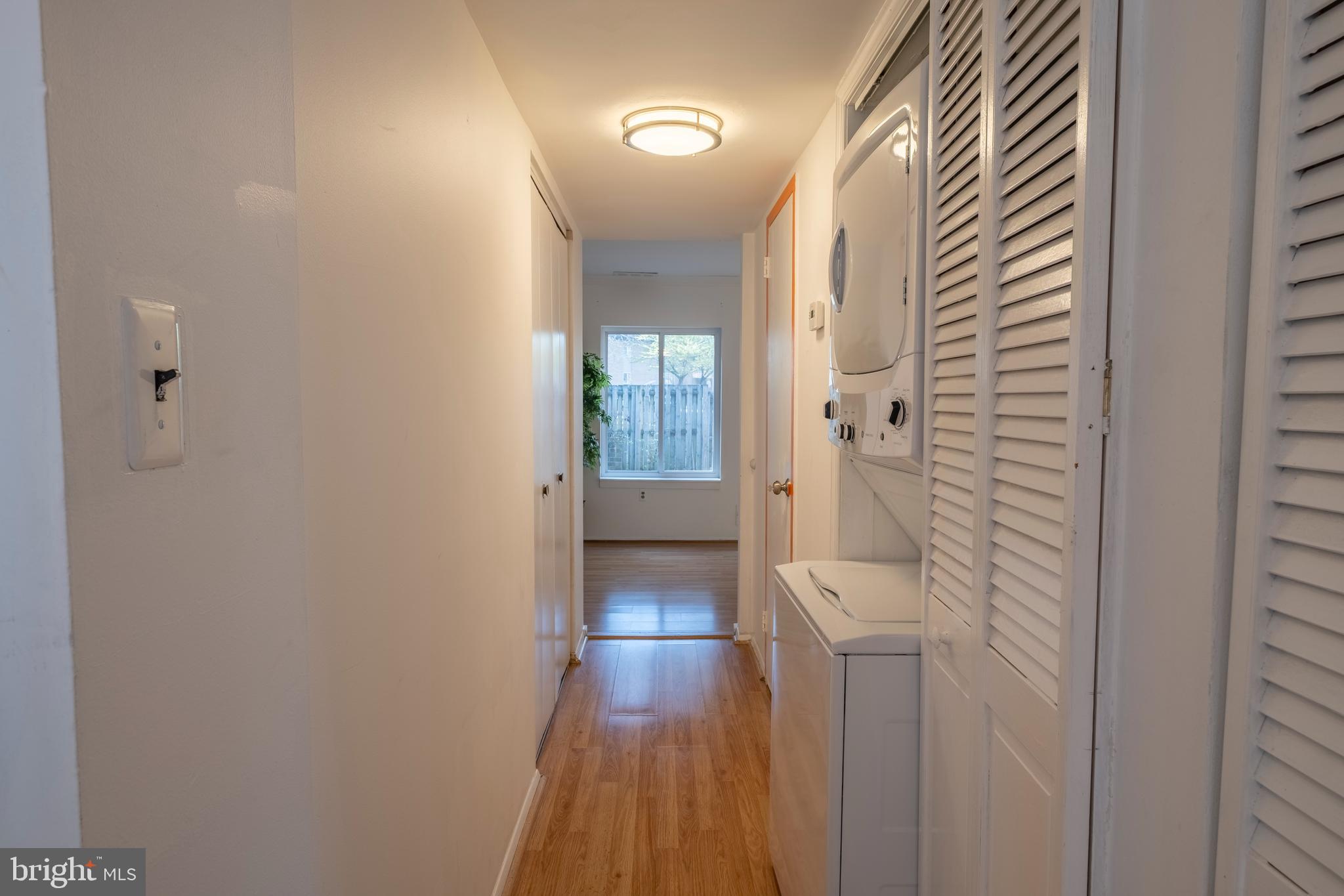 9637 Horizon Run Road, Unit 2H Montgomery Village, MD 20886 - Photo 13 of 28 a view of a hallway with wooden floor and a bathroom