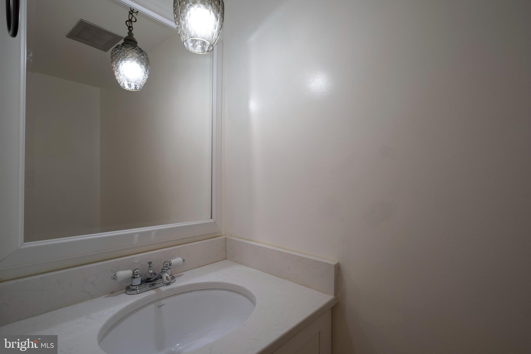 9637 Horizon Run Road, Unit 2H Montgomery Village, MD 20886 - Photo 14 of 28 a bathroom with a sink and a mirror