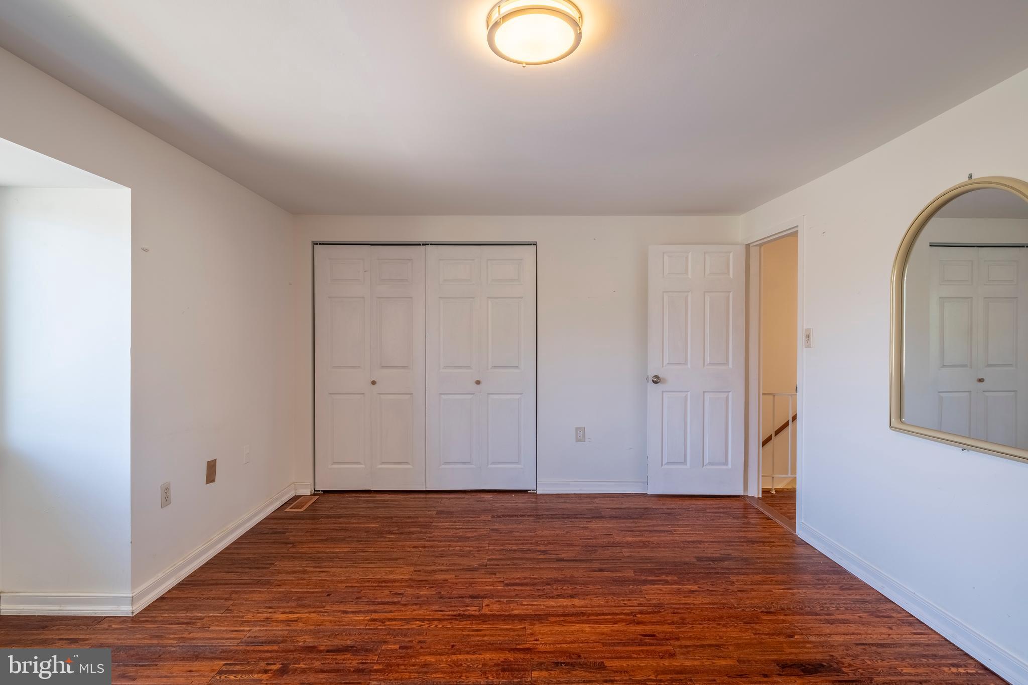 9637 Horizon Run Road, Unit 2H Montgomery Village, MD 20886 - Photo 18 of 28 a view of an empty room with wooden floor and a window