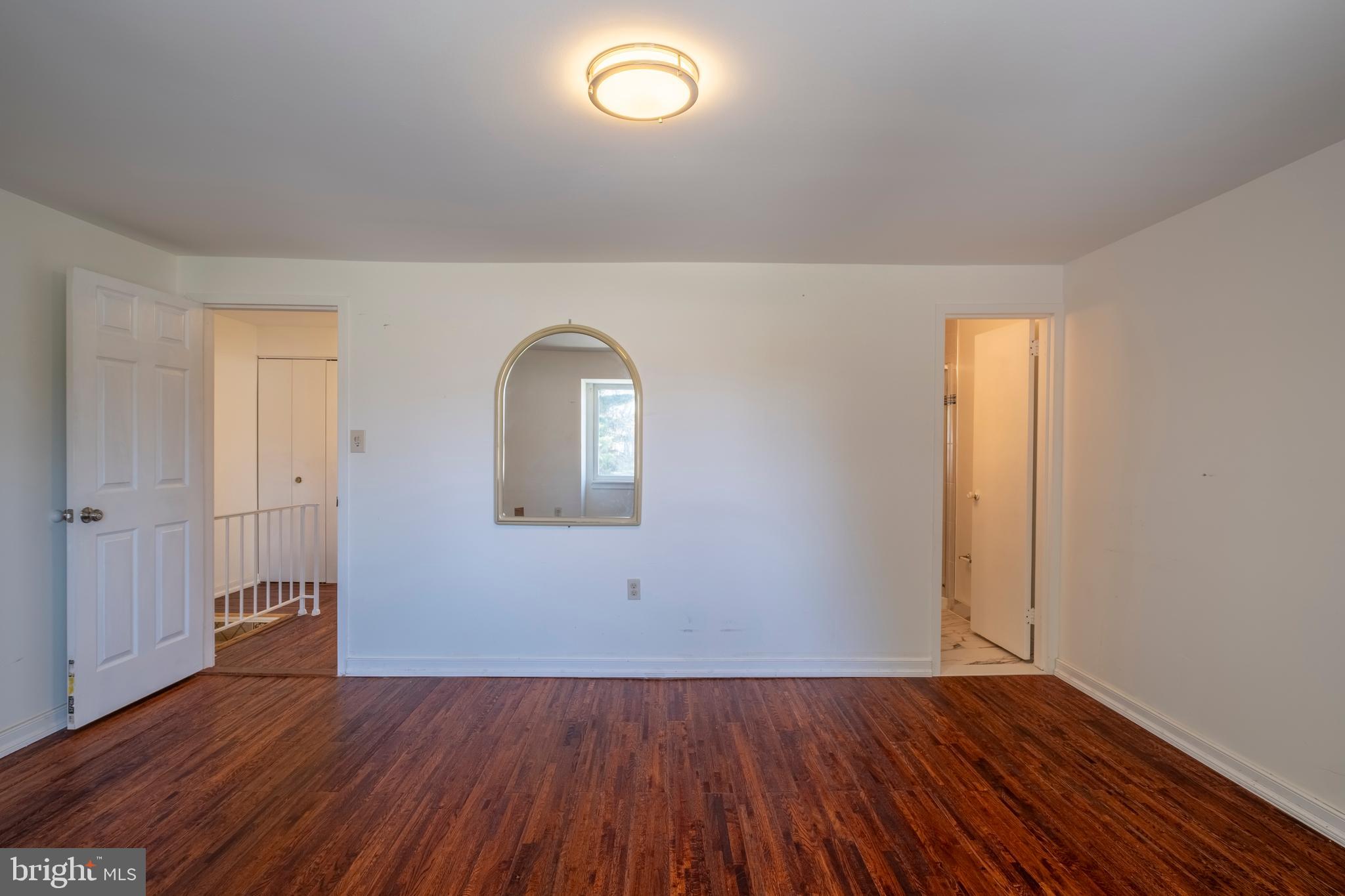 9637 Horizon Run Road, Unit 2H Montgomery Village, MD 20886 - Photo 19 of 28 an empty room with wooden floor and windows