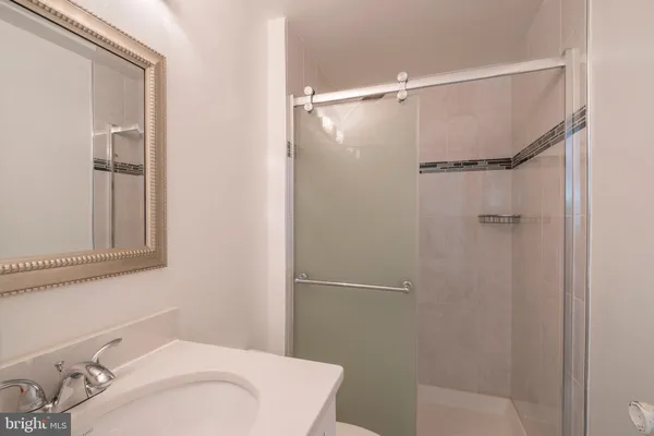 a bathroom with a sink and shower