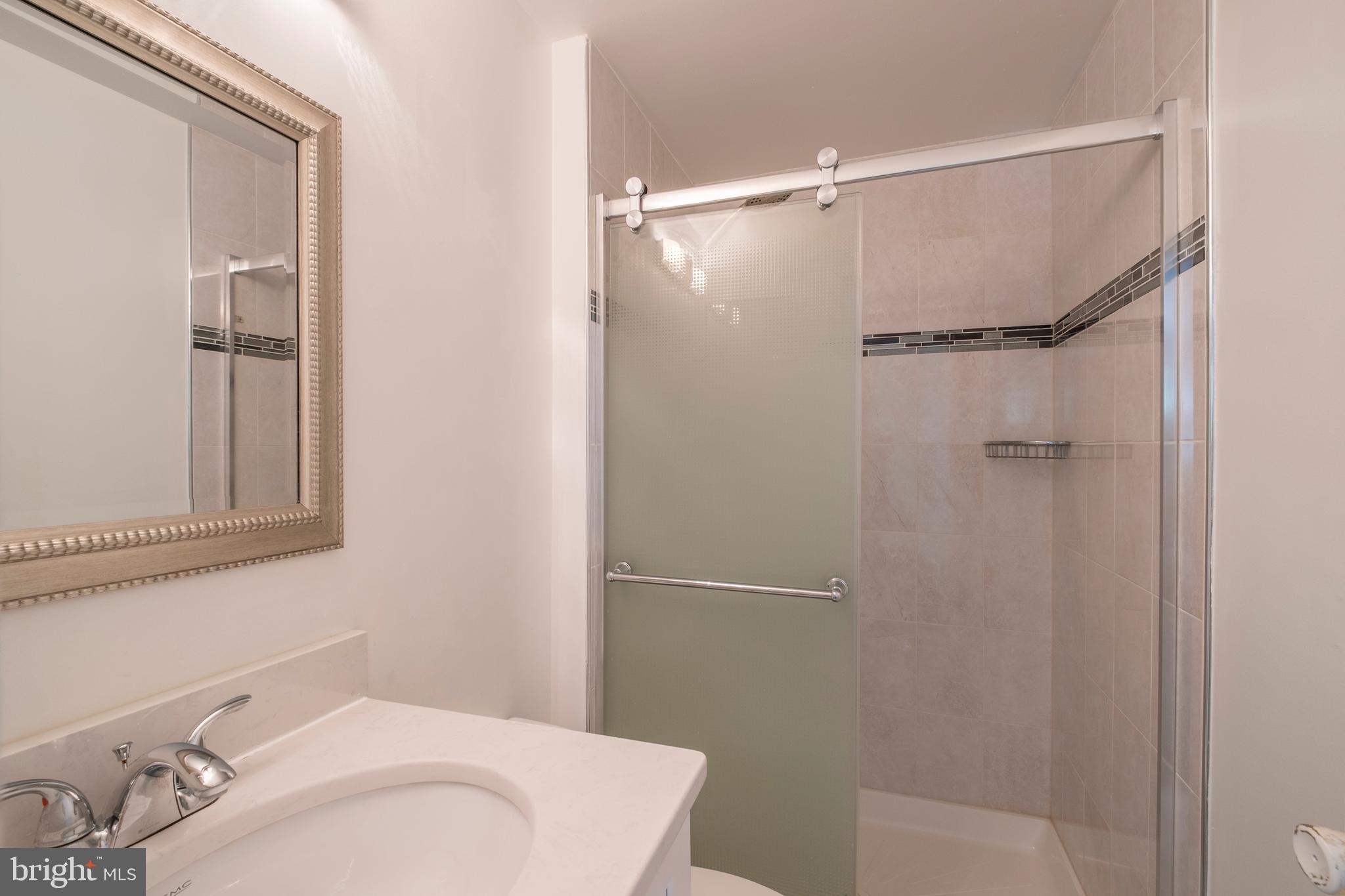 9637 Horizon Run Road, Unit 2H Montgomery Village, MD 20886 - Photo 20 of 28 a bathroom with a sink and shower