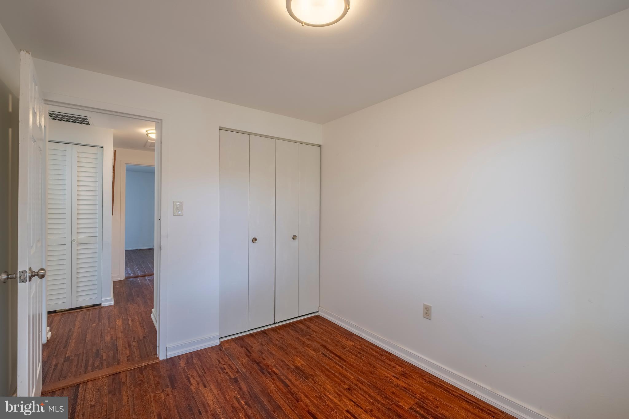 9637 Horizon Run Road, Unit 2H Montgomery Village, MD 20886 - Photo 23 of 28 a view of an empty room with wooden floor and a window
