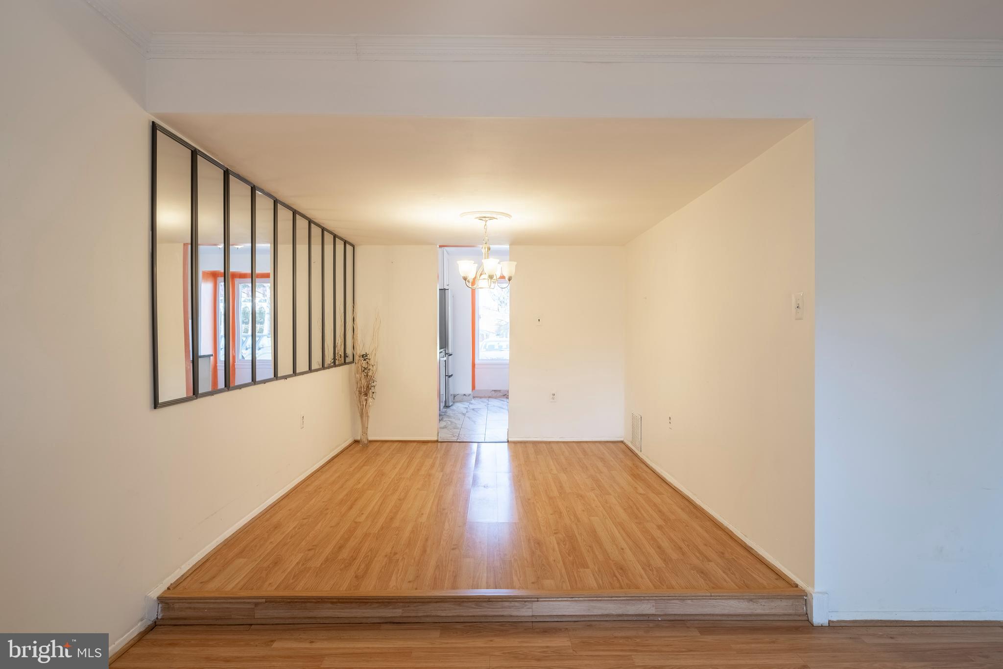9637 Horizon Run Road, Unit 2H Montgomery Village, MD 20886 - Photo 6 of 28 a view of an empty room with wooden floor and a window