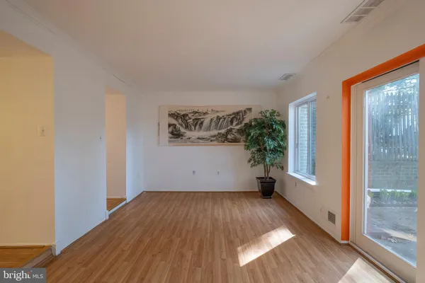a view of a room with wooden floor and a window