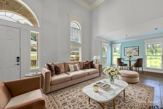 a living room with furniture couches and a table