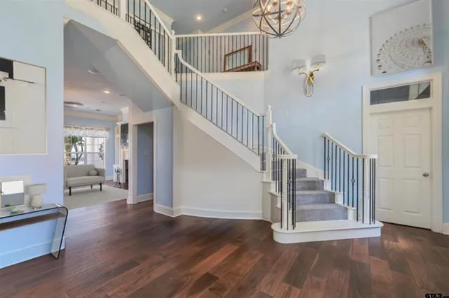a view of entryway and hall with wooden floor