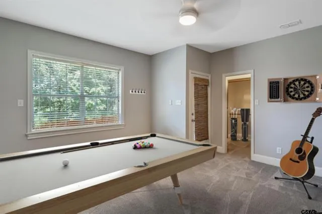 a view of a room with gym equipment and a window