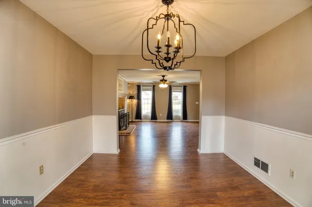 a view of hallway with wooden floor