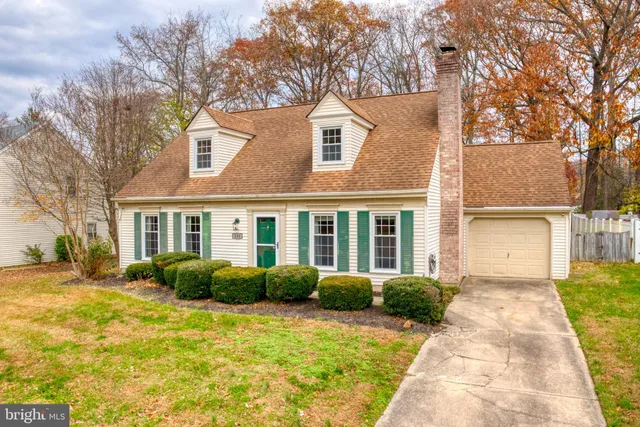 a front view of house with yard and trees around