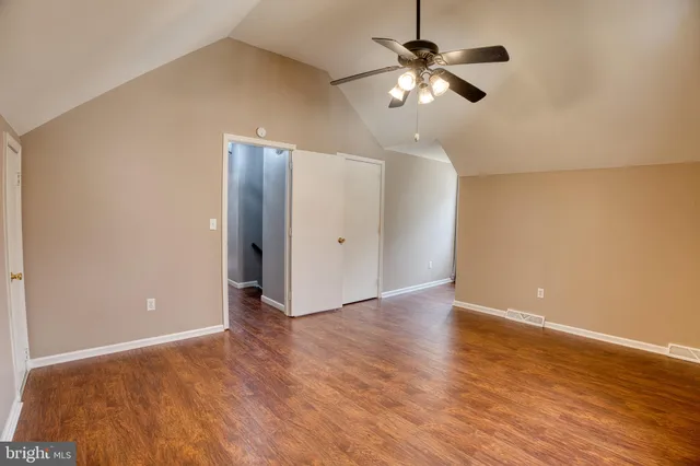 an empty room with fan and a ceiling fan