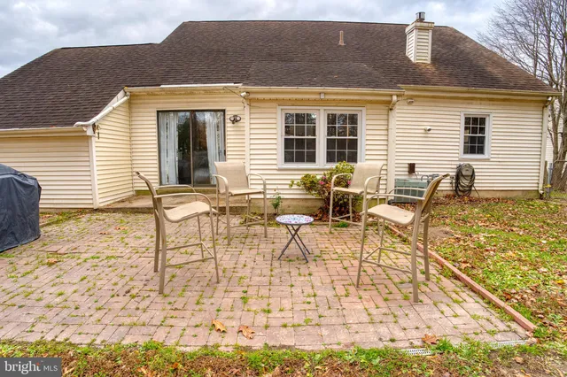 a view of a patio with a table and chairs