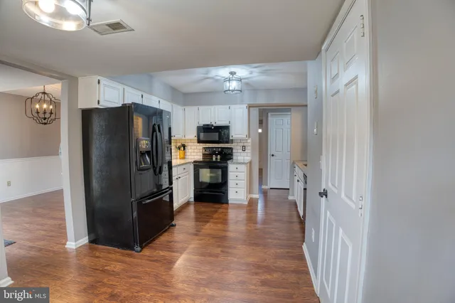 a kitchen with stainless steel appliances a refrigerator and microwave