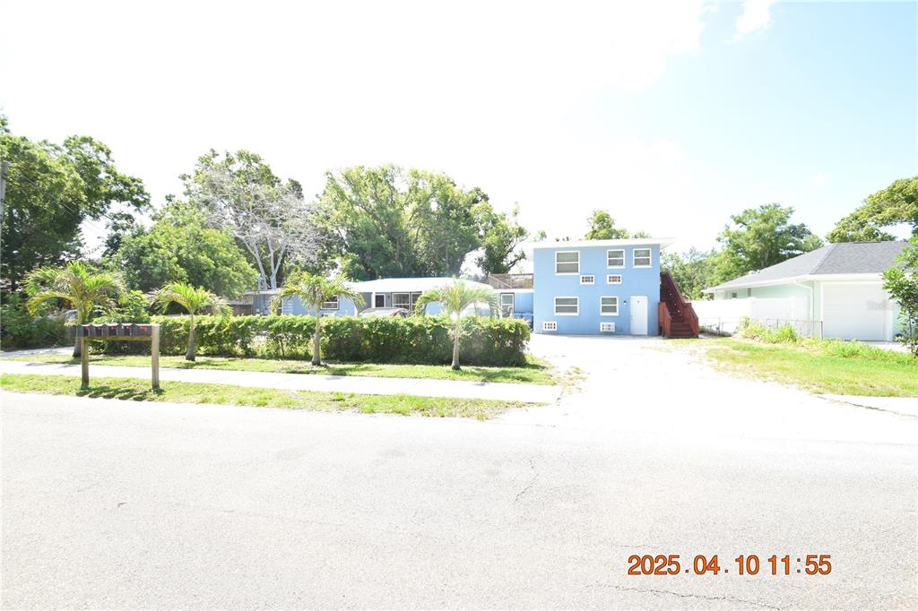 a view of a house with a yard and sitting area