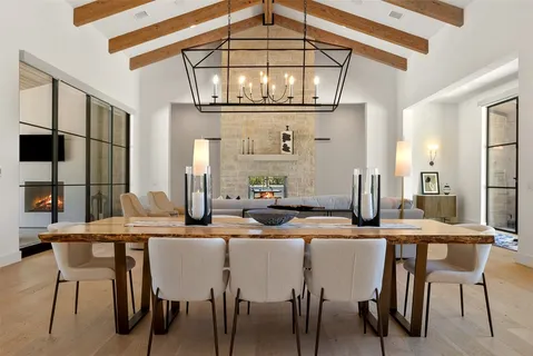 a living room with furniture and floor to ceiling windows