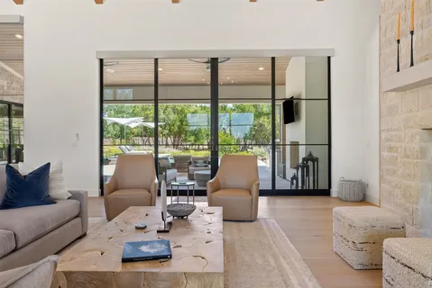 a living room with furniture and chandelier