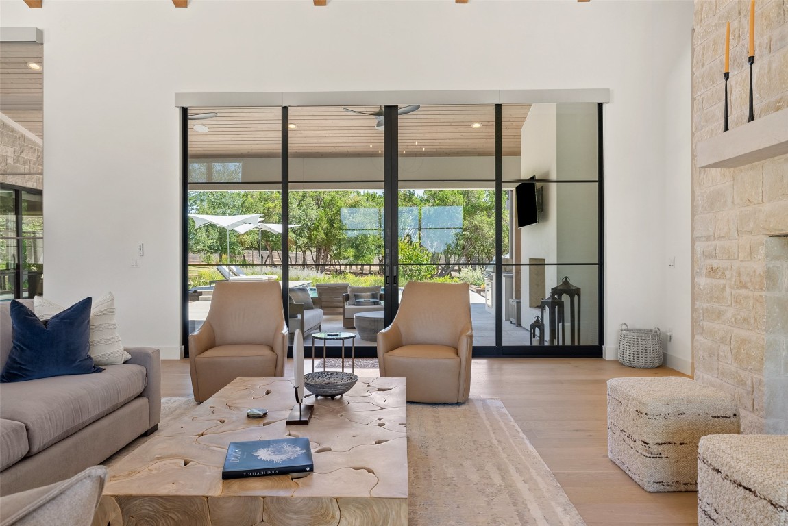 15236 Grumbles Lane Austin, TX 78738 - Photo 17 of 37 a living room with furniture and floor to ceiling windows