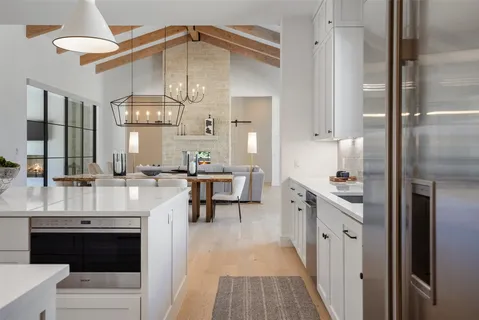 a kitchen with stainless steel appliances a stove a sink and a refrigerator