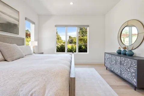 a large white kitchen with a stove and a refrigerator