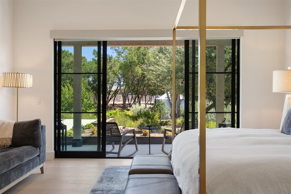 15236 Grumbles Lane Austin, TX 78738 - Photo 33 of 37 a bedroom with a bed and a large window