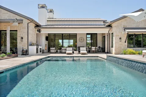 a bedroom with a bed a couch and a large window